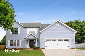 High Point house for rent - A blue house with a white garage door and a black door.