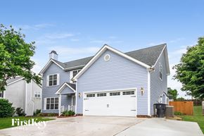 High Point house for rent - A blue house with a white garage door.