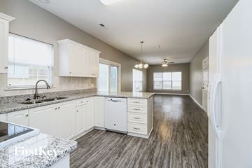 High Point house for rent - A kitchen with white cabinets and a marble countertop.