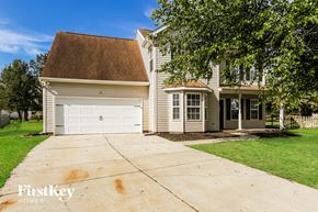 Concord house for rent - A house with a brown roof and a garage door is for sale.