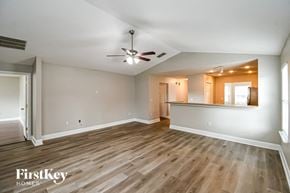 Jacksonville house for rent - a living room and kitchen with wood flooring and a ceiling fan