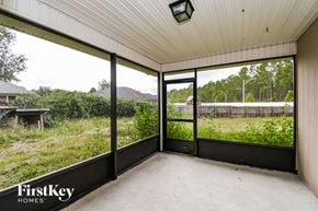 Jacksonville house for rent - a screened in porch with a view of a field and trees