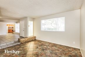 Phoenix house for rent - A room with a tile floor and a window showing trees outside.