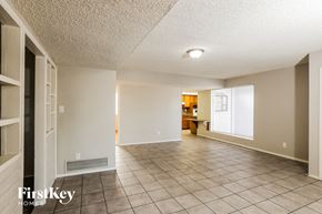 Phoenix house for rent - A spacious room with tile flooring and a ceiling light.