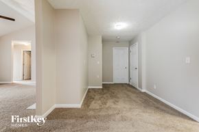 Winder house for rent - a spacious living room with carpet and a door to a bedroom
