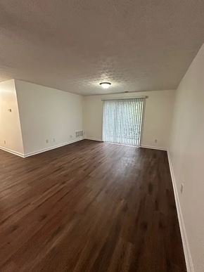 Cincinnati apartment for rent - A room with wooden flooring and a window with blinds.