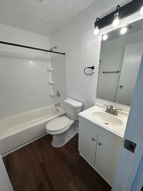 Cincinnati apartment for rent - A white toilet sits next to a white sink in a small bathroom.