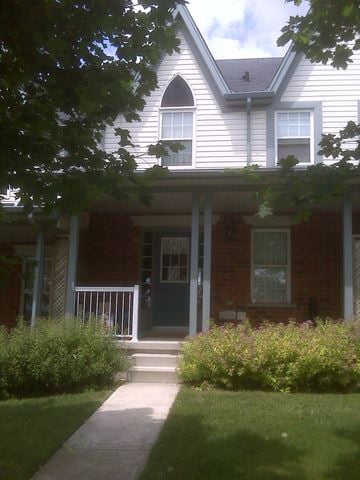 Guelph apartment for rent - a house with a porch and a walkway in front of it