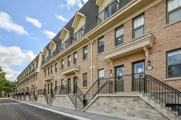 Guelph apartment for rent - a large brick building with stairs and a street in front