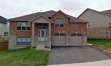 Guelph apartment for rent - A house with a brick facade and a garage door.