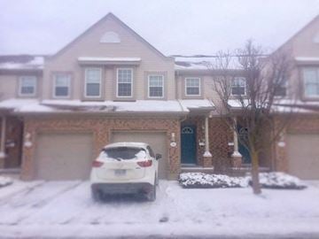 Guelph apartment for rent - a car parked in the snow in front of a house