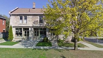 Guelph apartment for rent - A house with a tree in front of it.