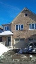 Guelph apartment for rent - a brick house with a car parked in front of it