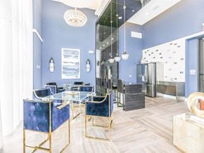 Margate apartment for rent - a dining room with blue chairs and a glass table