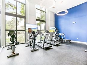 Margate apartment for rent - a gym with cardio machines and windows in a building