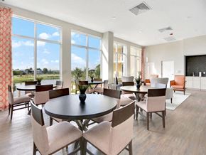 Riviera Beach apartment for rent - a dining room with tables and chairs and large windows