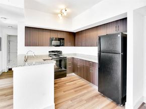 Riviera Beach apartment for rent - a kitchen with stainless steel appliances and wooden cabinets