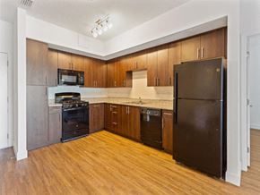Titusville apartment for rent - a large kitchen with black appliances and wood floors