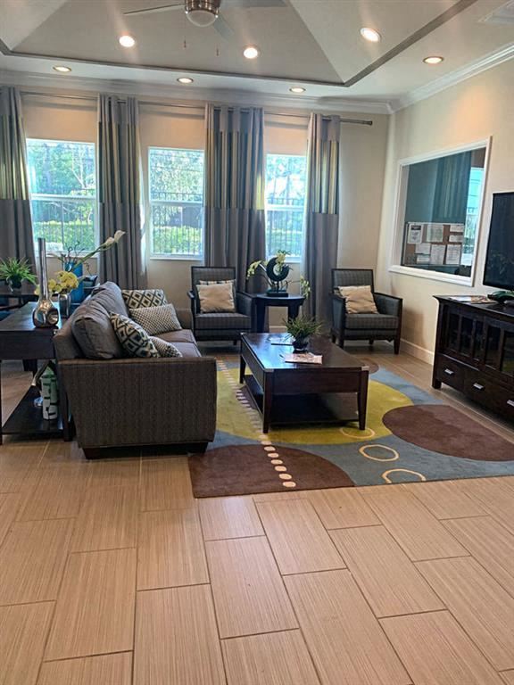 Lake Worth apartment for rent - A living room with a brown couch, a coffee table, and a TV.