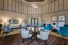 Eustis apartment for rent - a living room with blue chairs and a round table