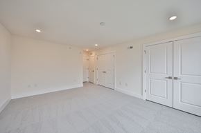 Philadelphia apartment for rent - a bedroom with white closets and white carpeting and white doors