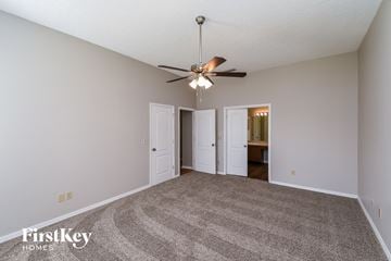 Jacksonville house for rent - a spacious living room with carpet and a ceiling fan