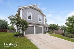 Overland Park house for rent - a gray house with a driveway and a garage door