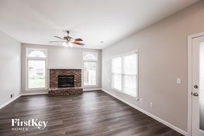 Overland Park house for rent - a living room with a fireplace and a ceiling fan