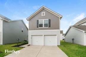 Midland house for rent - a white and gray house with a white garage door