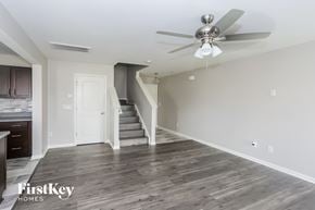 Midland house for rent - a living room with white walls and a ceiling fan
