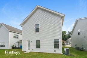 Midland house for rent - a white house with white siding and a grassy yard