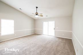 North Charleston house for rent - an empty living room with a ceiling fan and white walls