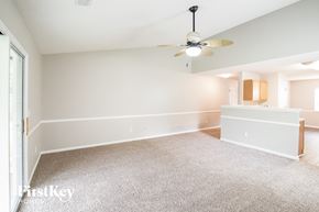 North Charleston house for rent - an empty living room with a ceiling fan and a kitchen