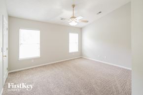 North Charleston house for rent - a bedroom with carpet and a ceiling fan