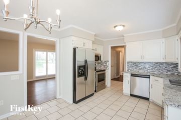 Kansas City house for rent - A kitchen with a refrigerator, dishwasher, and oven.