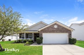 Plainfield house for rent - a home with a white garage door in front of it