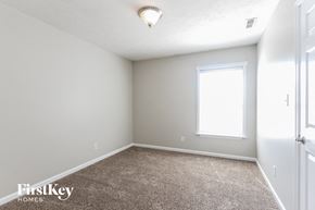 Plainfield house for rent - a bedroom with a carpeted floor and a window