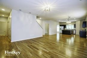 Lithopolis house for rent - an empty living room with a hard wood floor and white walls