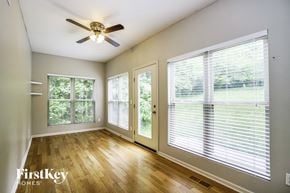 Lithopolis house for rent - an empty living room with large windows and a ceiling fan