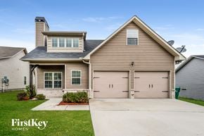 Odenville house for rent - A house with a garage and a driveway in front of it.