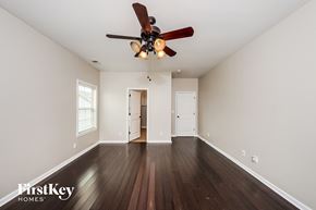 Odenville house for rent - A spacious room with a ceiling fan and wooden floors.