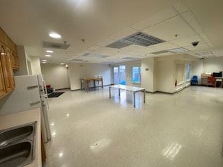 San Francisco apartment for rent - A large, empty room with a kitchen area on the left side.