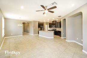San Antonio house for rent - an empty living room with a ceiling fan and a kitchen