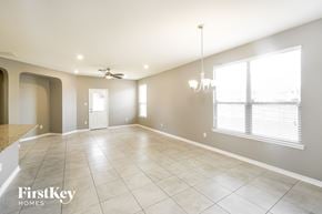San Antonio house for rent - an empty living room with a ceiling fan and a large window