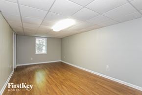 Loganville house for rent - the living room and dining room of a house with wood flooring and a window