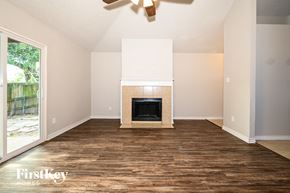 Balch Springs house for rent - a living room with wood flooring and a fireplace