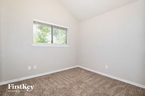 Balch Springs house for rent - the bedroom of a small house with carpet and a window