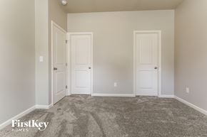 Flowery Branch house for rent - a bedroom with two doors and a carpeted floor