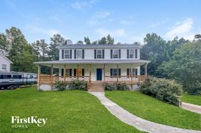 Dallas house for rent - a large white house with a porch and a lawn