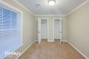 Dallas house for rent - a bedroom with a large window and a door to a closet